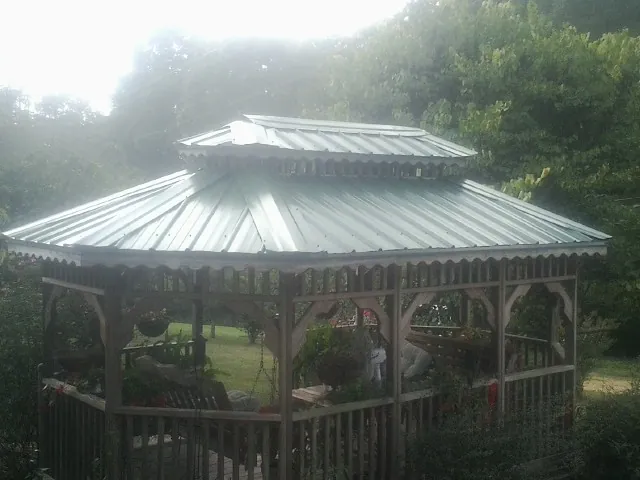 Two tier green metal roof on a garden gazebo in Rogue River